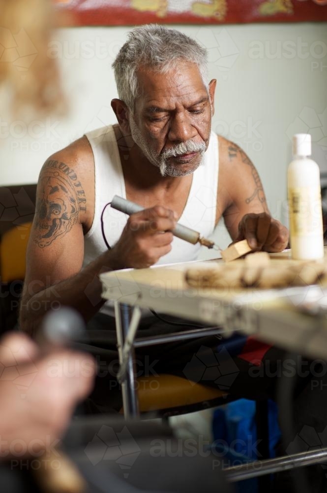 Aboriginal Artist at Work at Table - Australian Stock Image