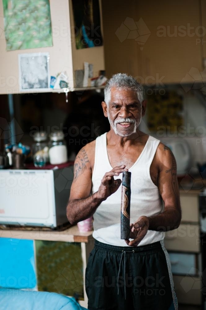 Aboriginal Artist holding Work of Art - Australian Stock Image