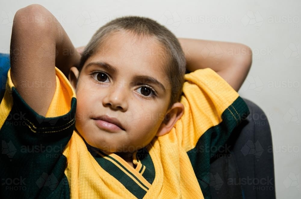 Aboriginal Boy with Arms Behind his Head - Australian Stock Image