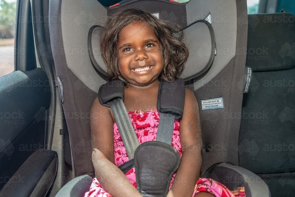 Aboriginal child in car seat - Australian Stock Image
