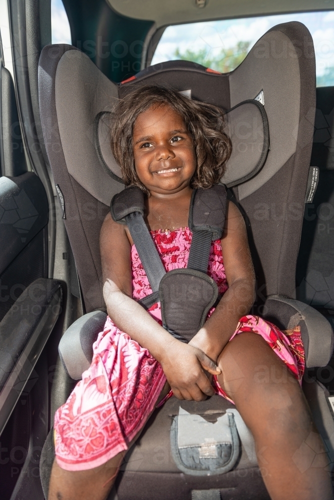 Aboriginal child in car seat - Australian Stock Image