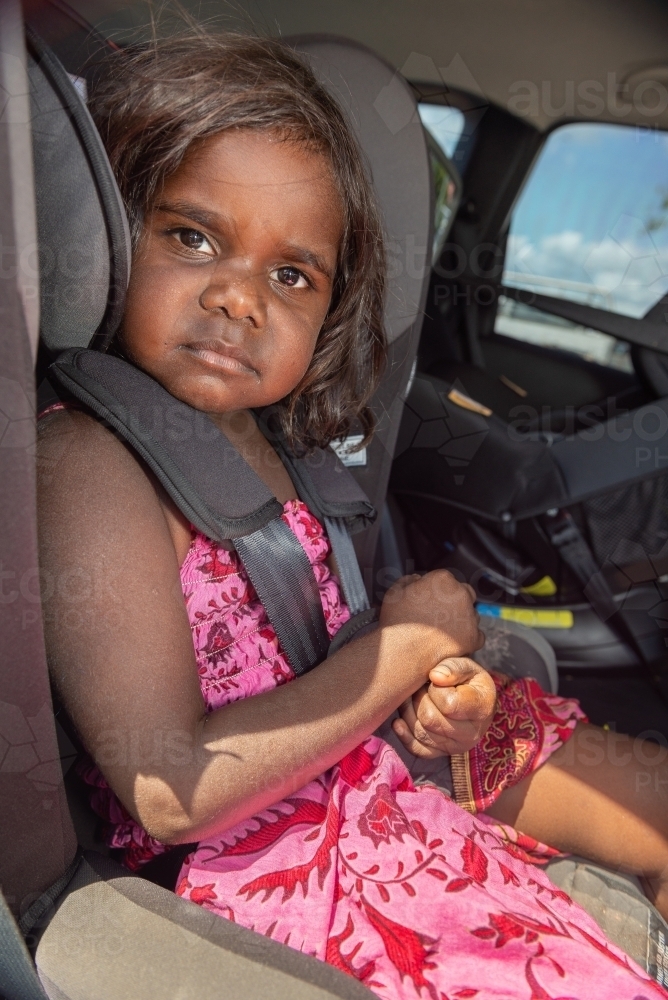 Aboriginal child in car seat - Australian Stock Image