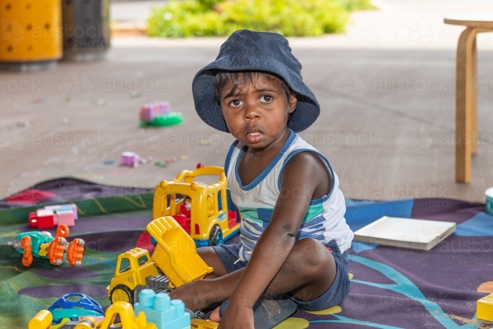 Aboriginal child playing with toys - Australian Stock Image