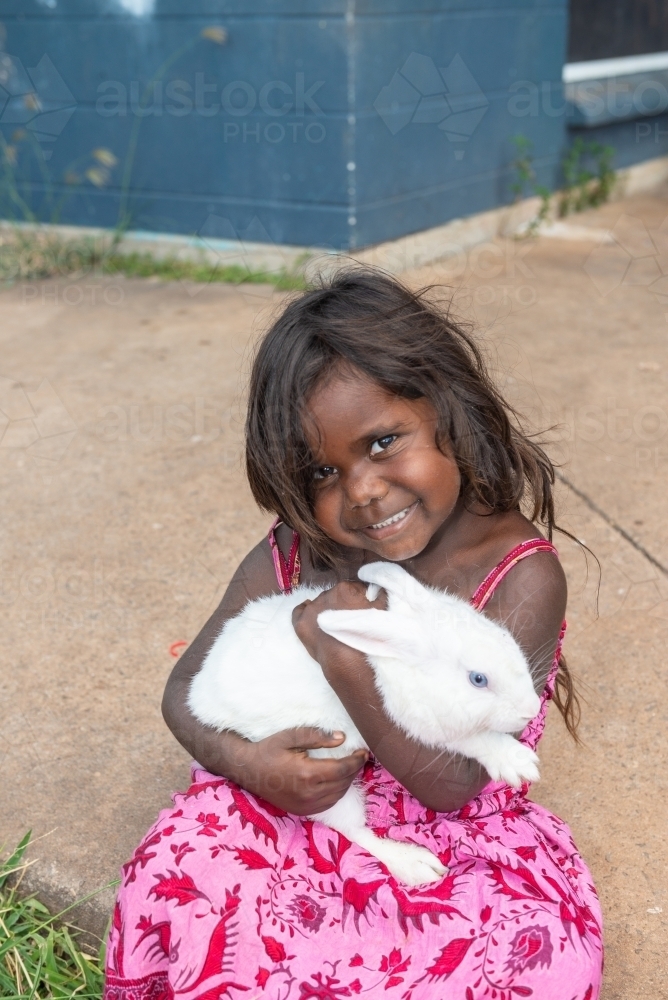 Image of Aboriginal child with pet rabbit - Austockphoto