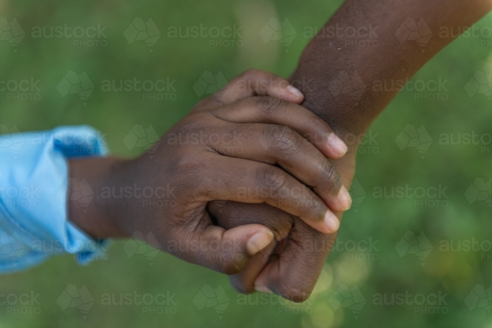 Aboriginal children holding hands - Australian Stock Image