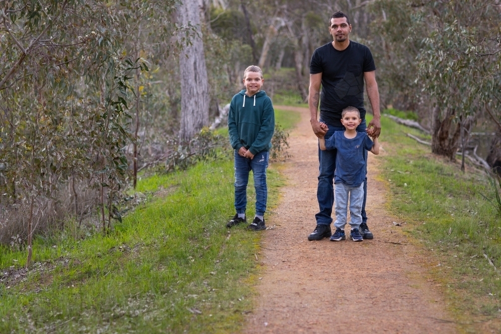 aboriginal family with father and two children - Australian Stock Image