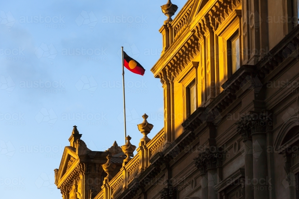 aboriginal flag flying above a heritage building - Australian Stock Image