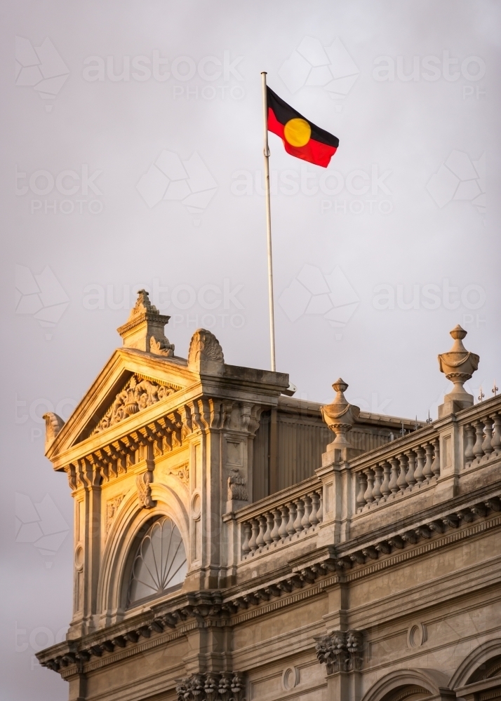 aboriginal flag flying above a heritage building - Australian Stock Image