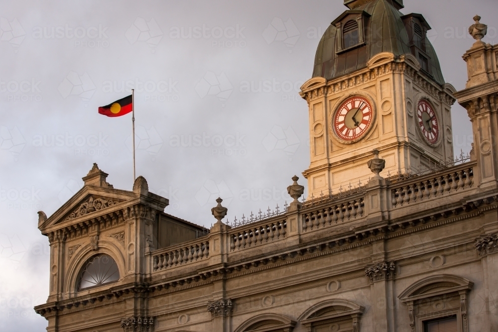 aboriginal flag flying above a heritage building - Australian Stock Image