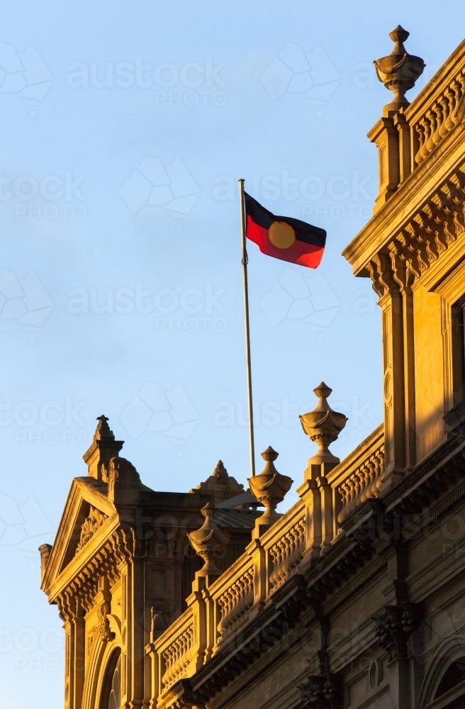 aboriginal flag flying above a heritage building - Australian Stock Image