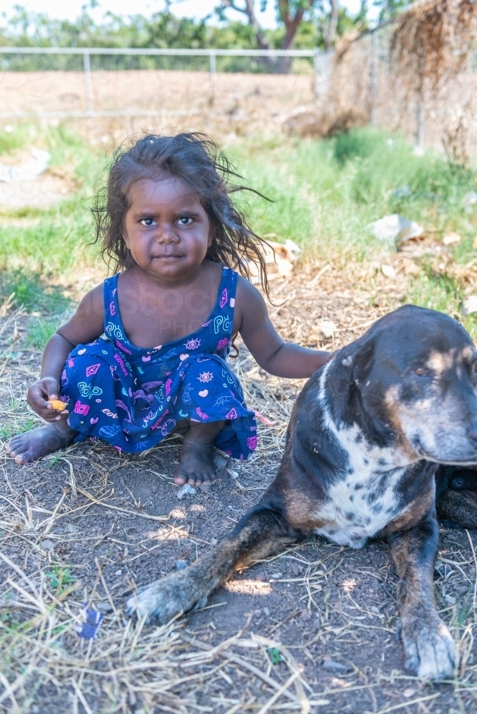 Aboriginal girl with old dog - Australian Stock Image