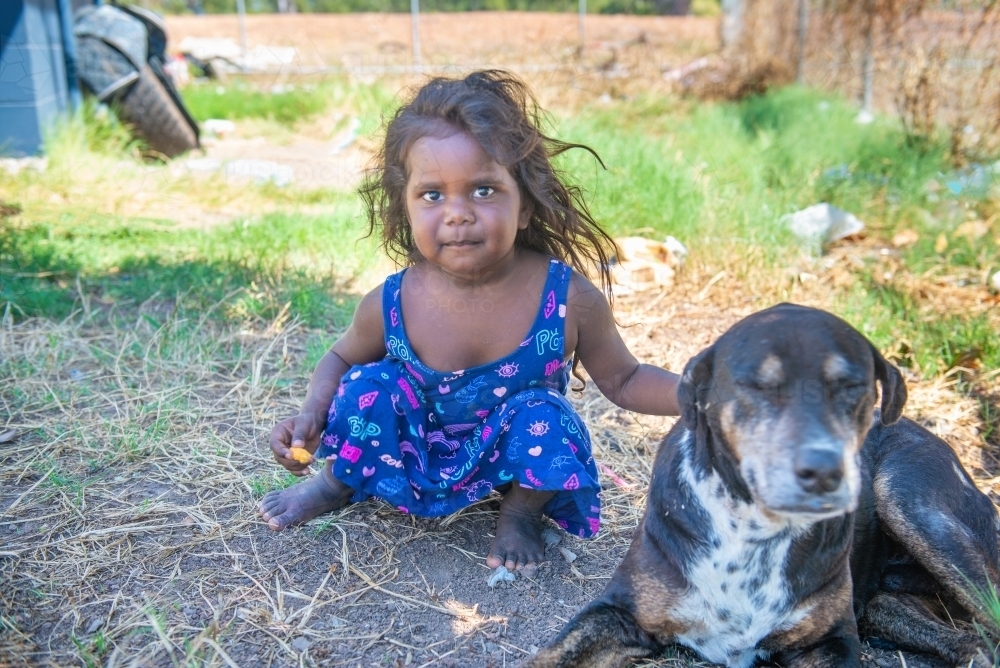 Aboriginal girl with old dog - Australian Stock Image