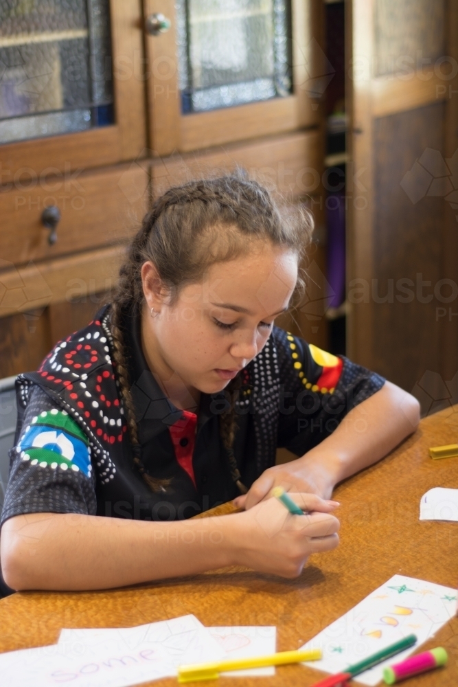 Aboriginal Girl writing - Australian Stock Image