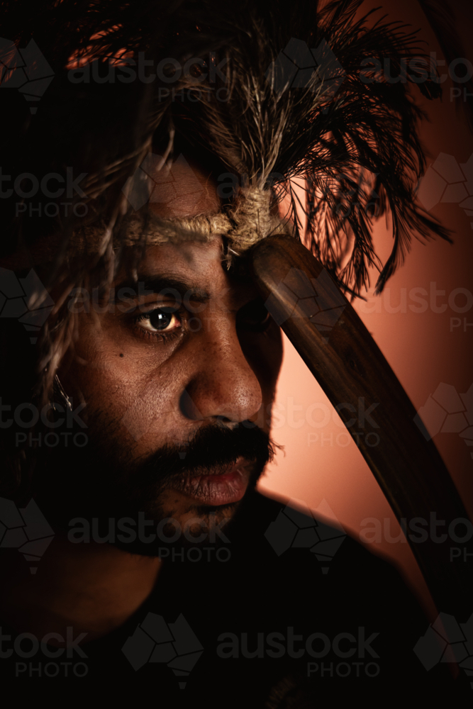Aboriginal male with headpiece covering one eye headshot - Australian Stock Image