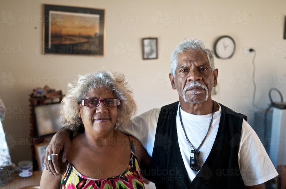 Aboriginal Man and Woman Standing in Living Room - Australian Stock Image