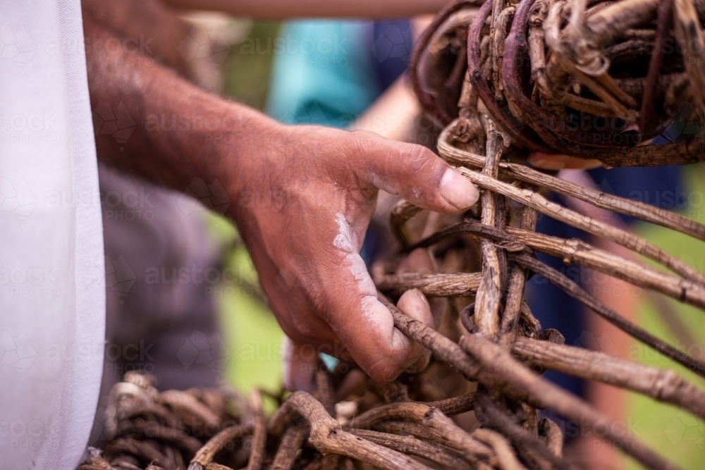 Aboriginal man holding a wooden basket - Australian Stock Image