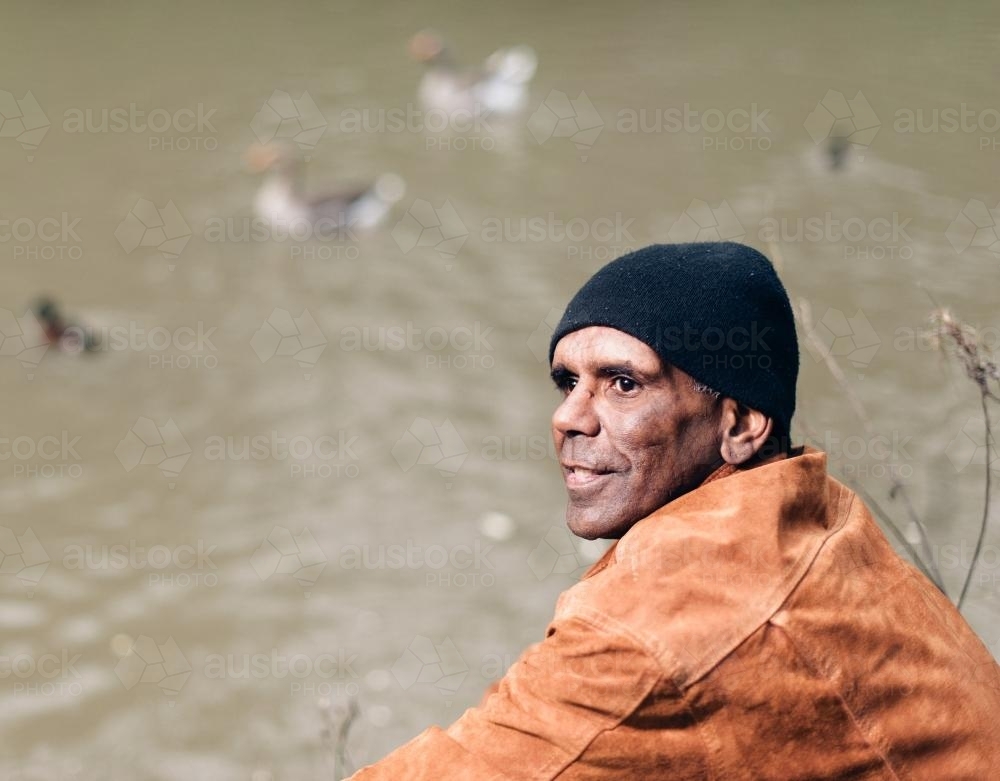 Aboriginal Man in his Forties, River in Background - Australian Stock Image