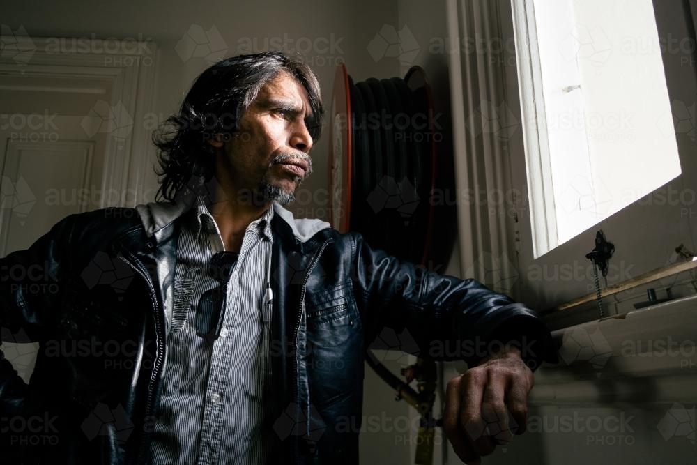 Aboriginal Man Looking out Window - Australian Stock Image