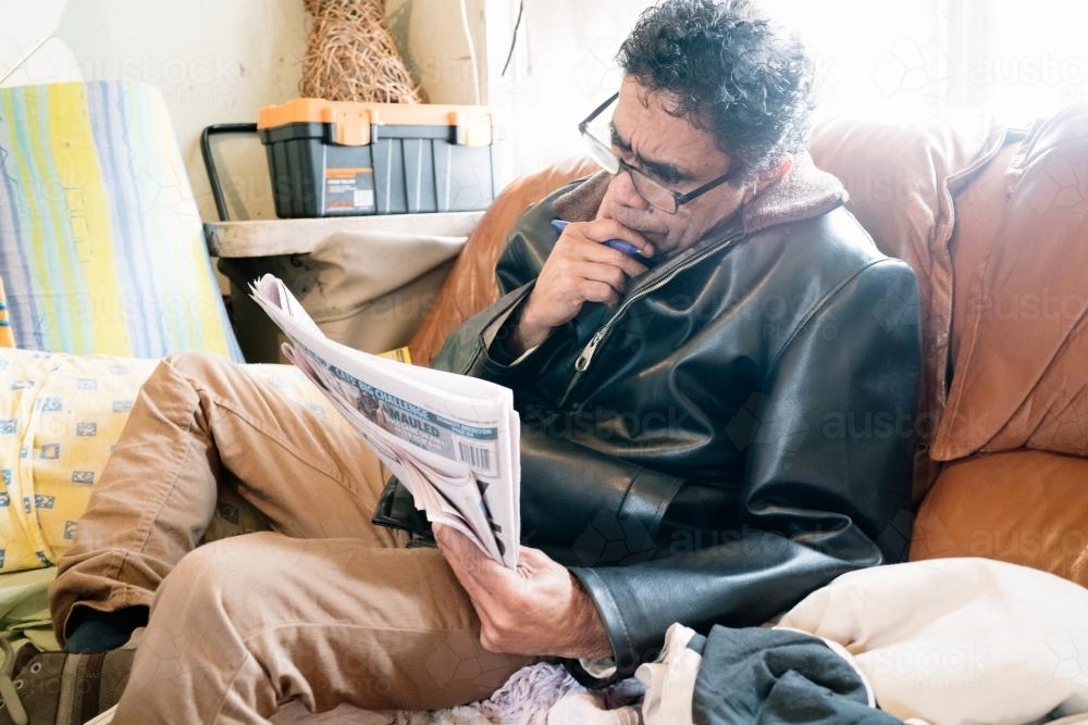 Aboriginal Man Reading a Newspaper - Australian Stock Image
