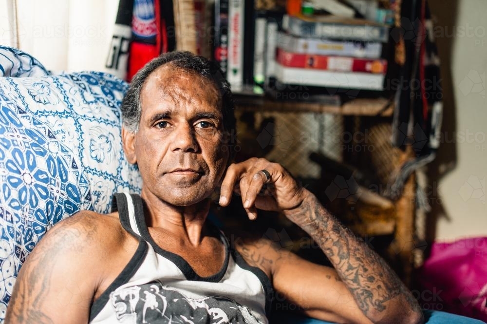 Aboriginal Man Seated in Loungeroom - Australian Stock Image