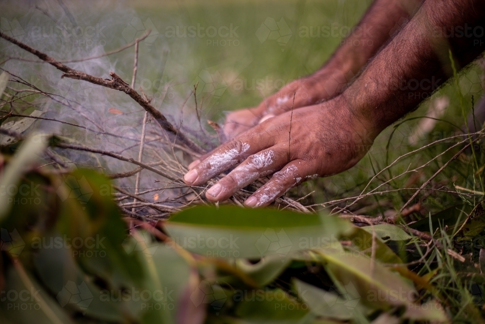 Aboriginal man starting a fire - Australian Stock Image