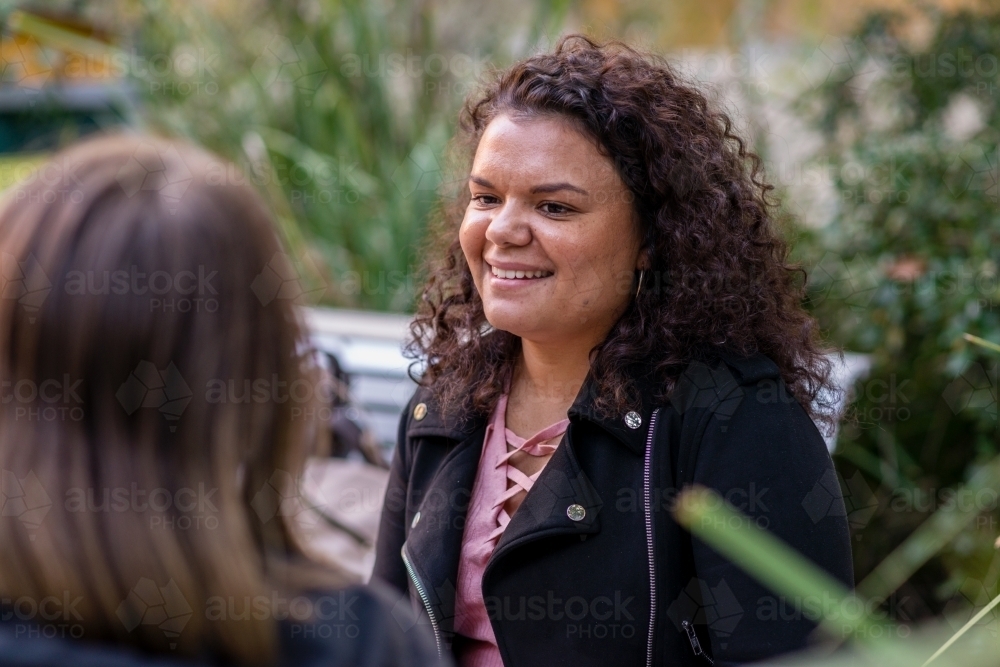 aboriginal student chatting with friend - Australian Stock Image