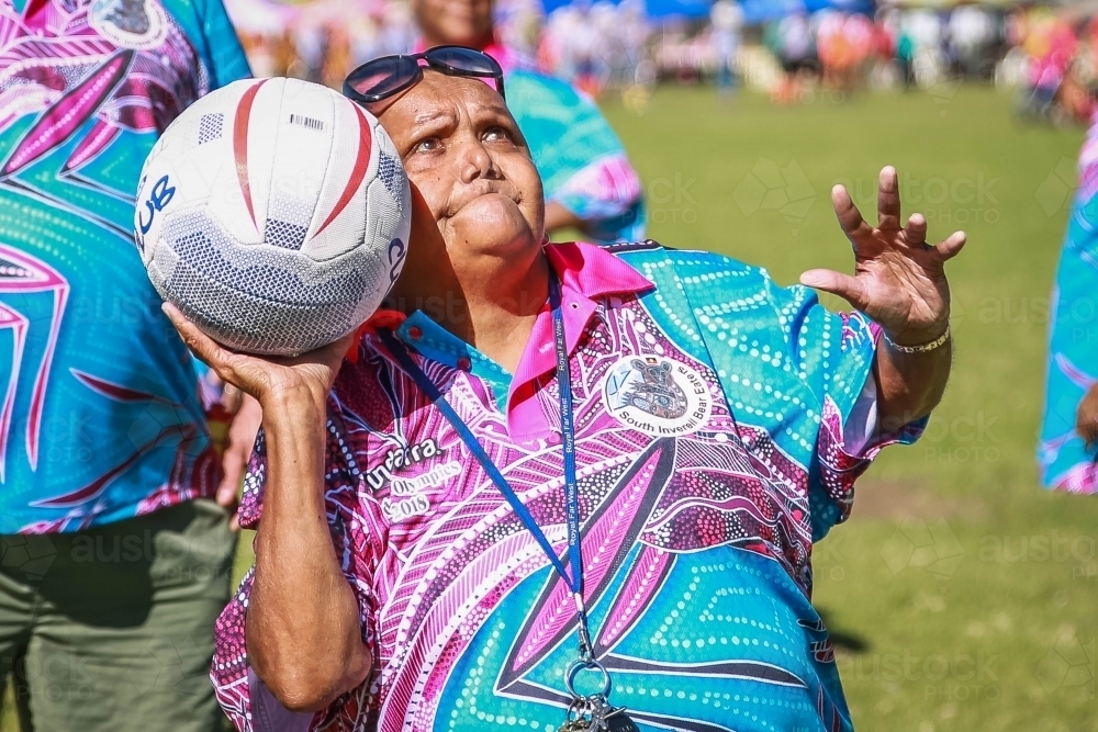 Aboriginal woman aiming getting ready to throw netball - Australian Stock Image