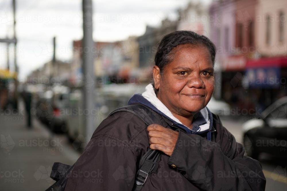 Aboriginal Woman on a Shopping Strip Footpath - Australian Stock Image