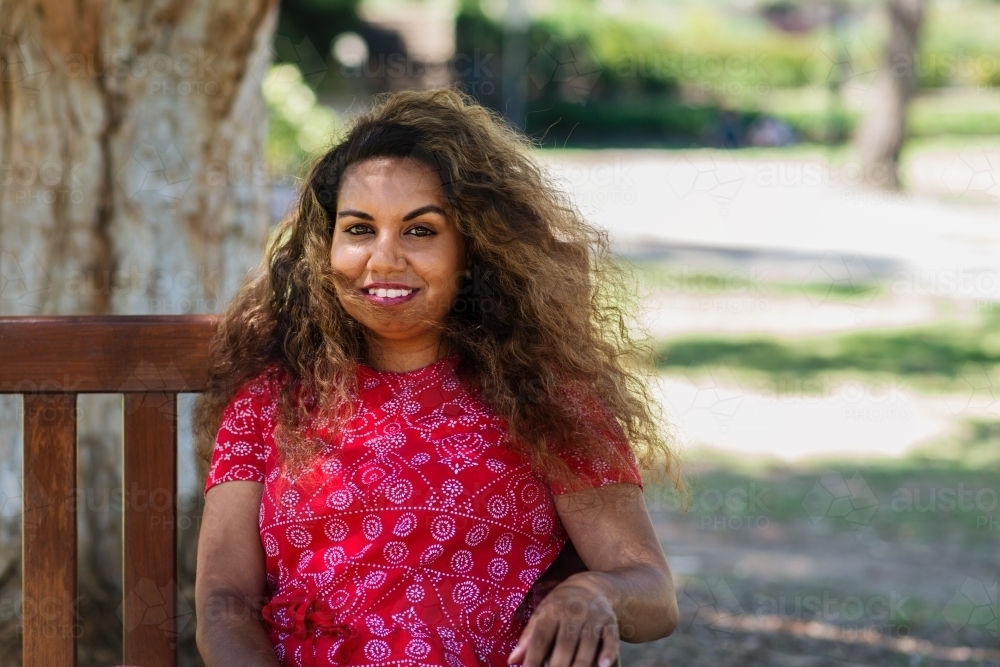 aboriginal woman on park bench - Australian Stock Image