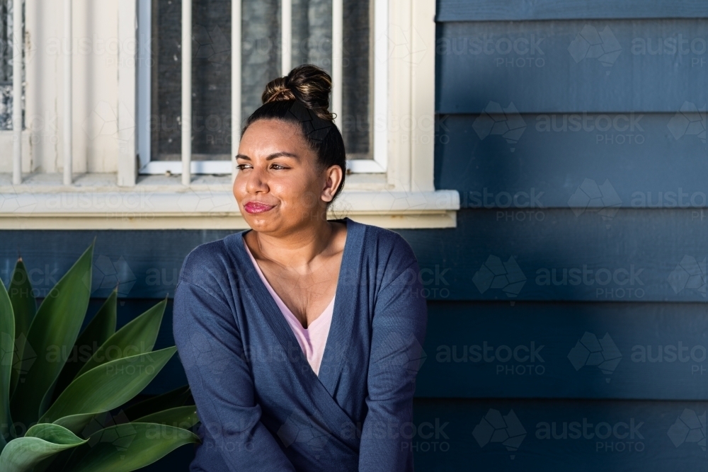 aboriginal woman outside home - Australian Stock Image