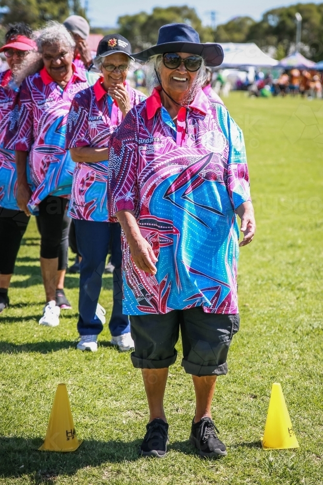 Aboriginal woman standing in line wearing hat - Australian Stock Image