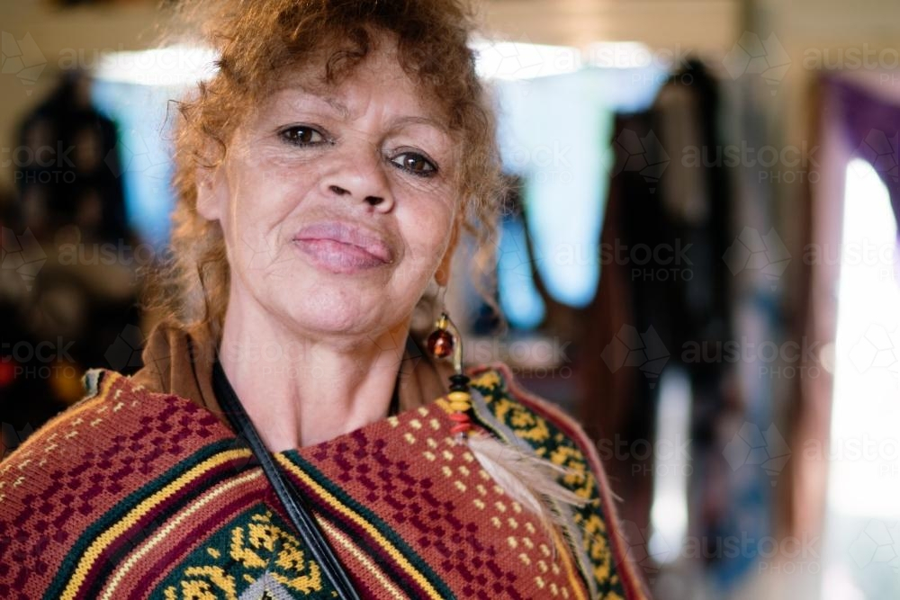Aboriginal Woman wearing a colourful drape with intricate patterns - Australian Stock Image