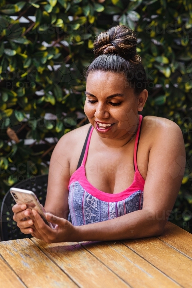 aboriginal woman with mobile phone - Australian Stock Image
