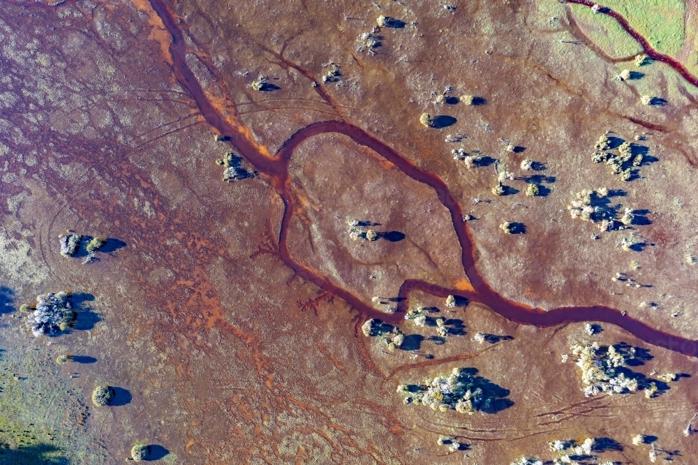 abstract aerial image of creek winding through wetland - Australian Stock Image