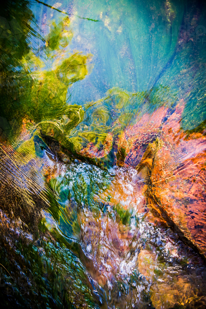 Abstract blend of light and water over river stones - Australian Stock Image