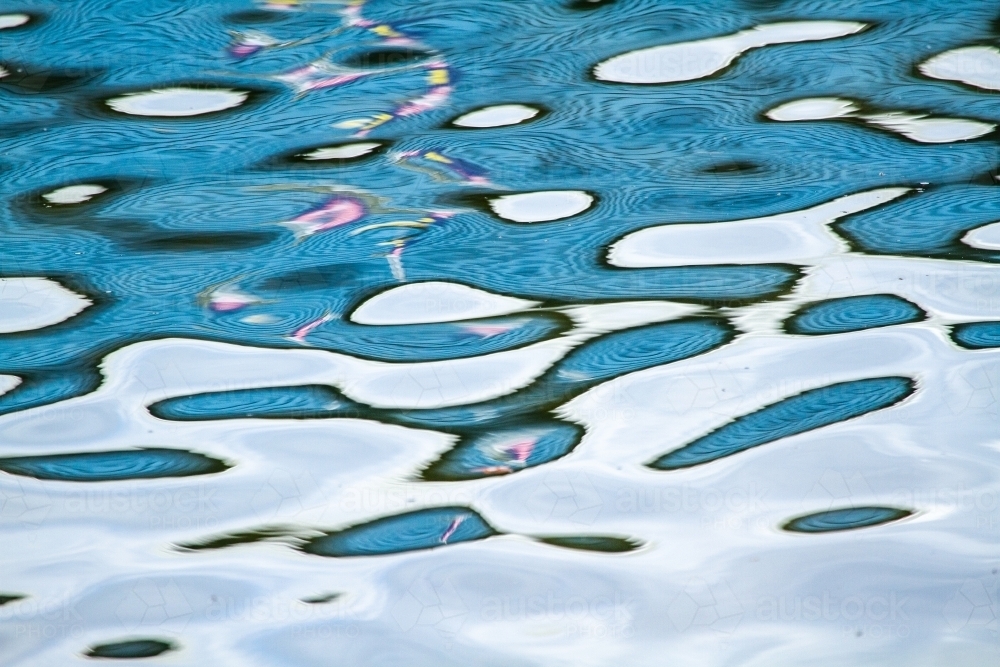 Abstract blue water reflection patterns. - Australian Stock Image