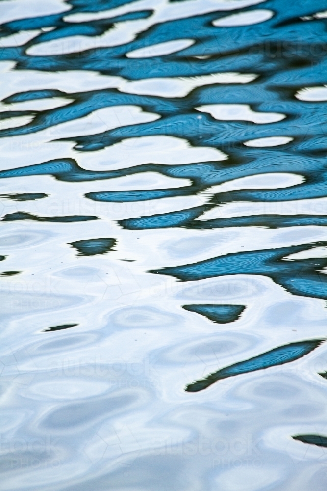 Abstract blue water reflection patterns. - Australian Stock Image
