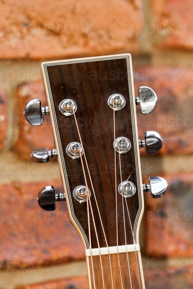 Acoustic guitar headstock showing string tuners. - Australian Stock Image