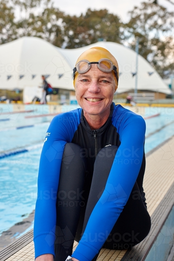 Active senior lady at swimming pool - Australian Stock Image