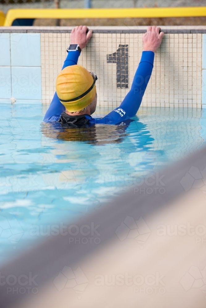 Active senior lady exercising in swimming pool - Australian Stock Image