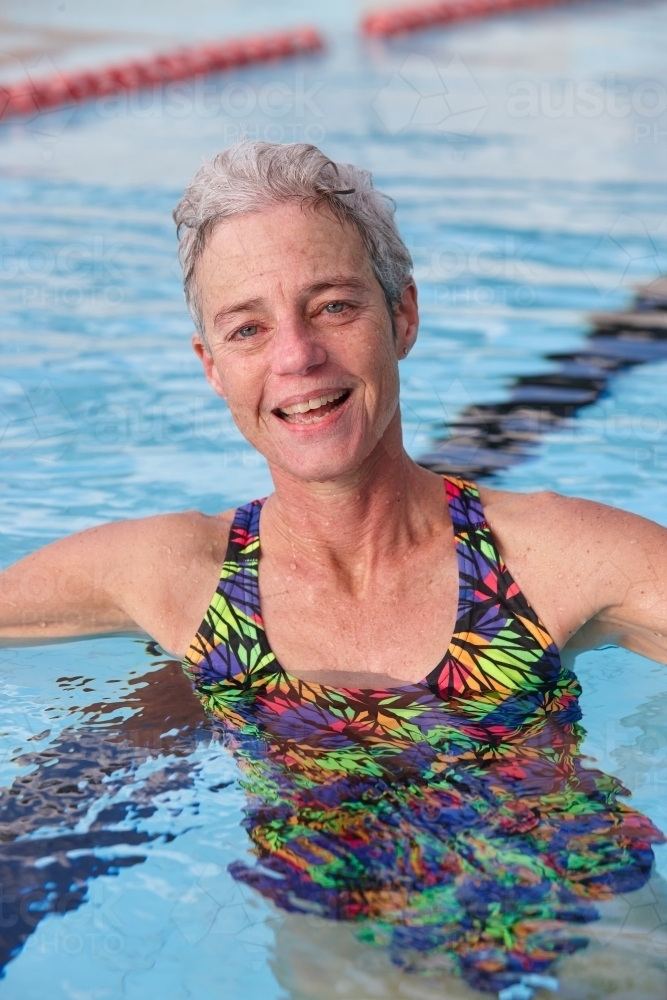 Active senior lady exercising in swimming pool - Australian Stock Image