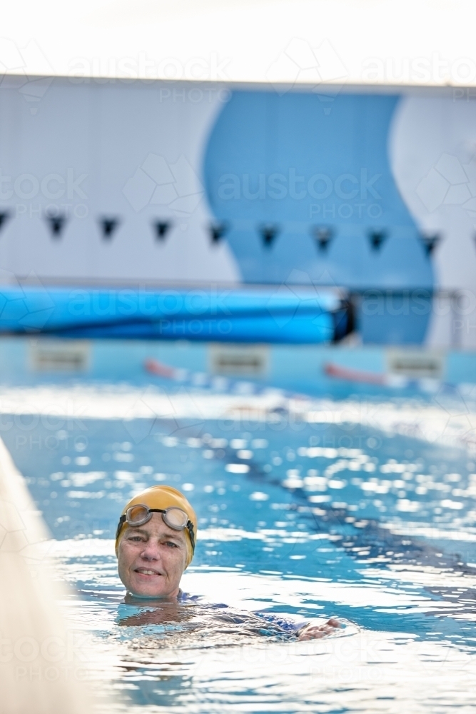 Active senior lady in swimming pool - Australian Stock Image