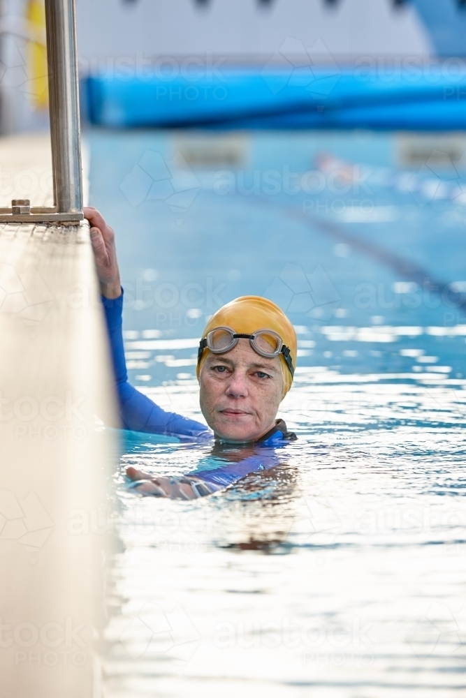 Active senior lady in swimming pool - Australian Stock Image