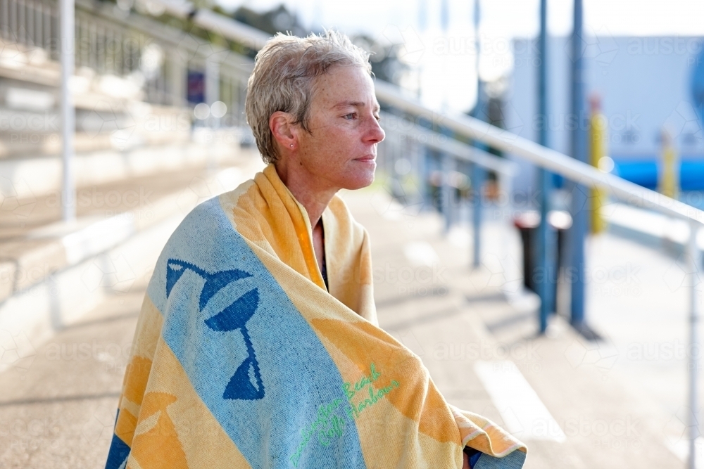 Active senior lady with towel at swimming pool - Australian Stock Image