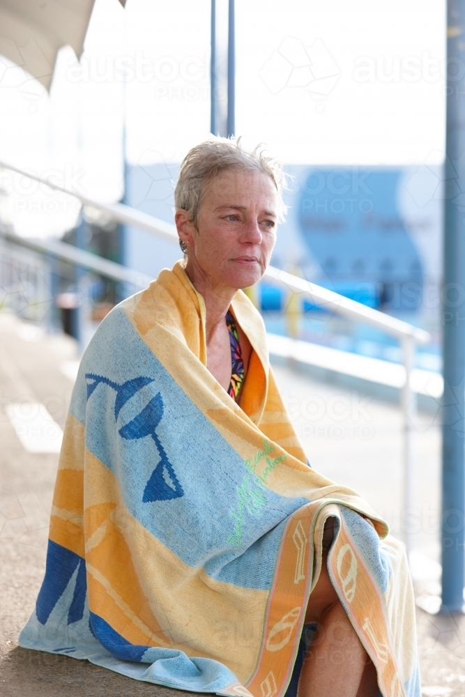 Active senior lady with towel at swimming pool - Australian Stock Image