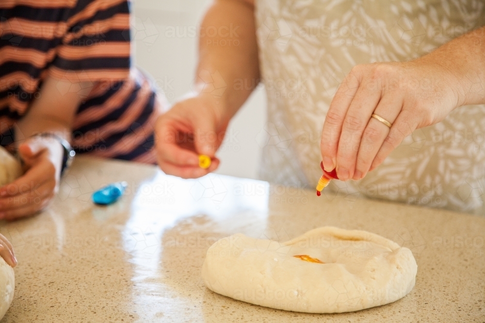 Adding colour to playdough dough - Australian Stock Image