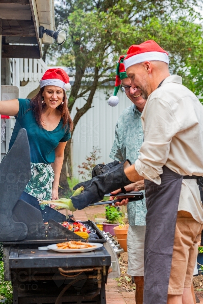 Adult father with his dad cooking the Christmas lunch bbq - Australian Stock Image