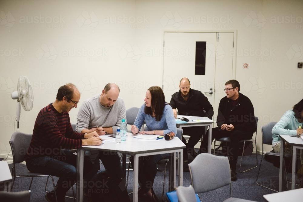 Adult students at a small group tutorial at university - Australian Stock Image