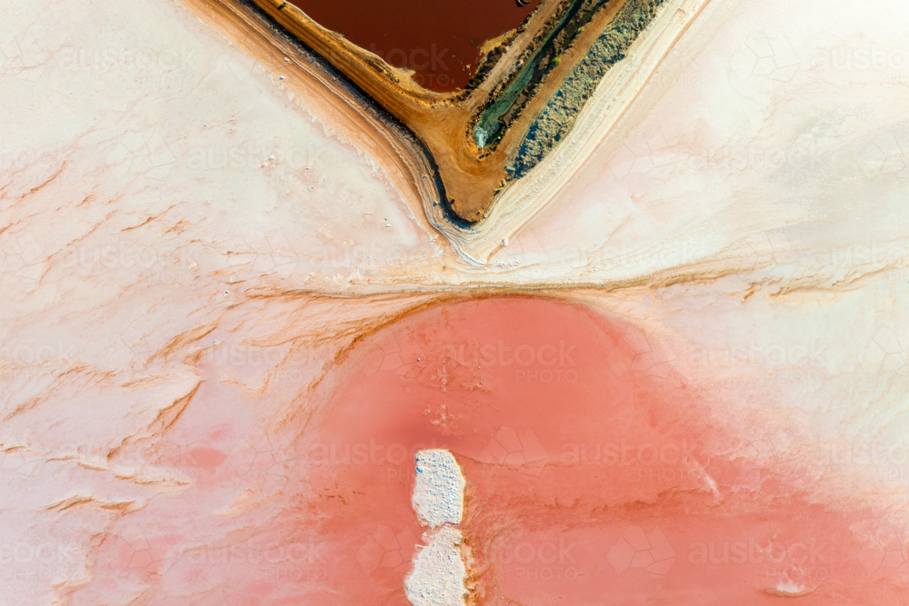 Aerial abstract of salt ponds with vivid red and pink tones. - Australian Stock Image