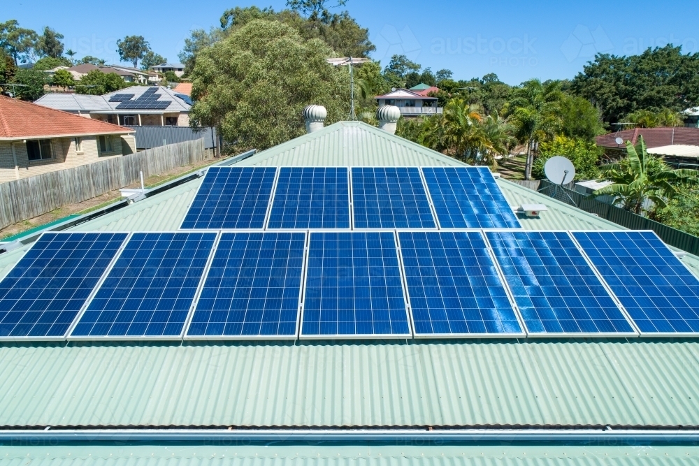 Aerial close-up of solar panels on metal roof. - Australian Stock Image